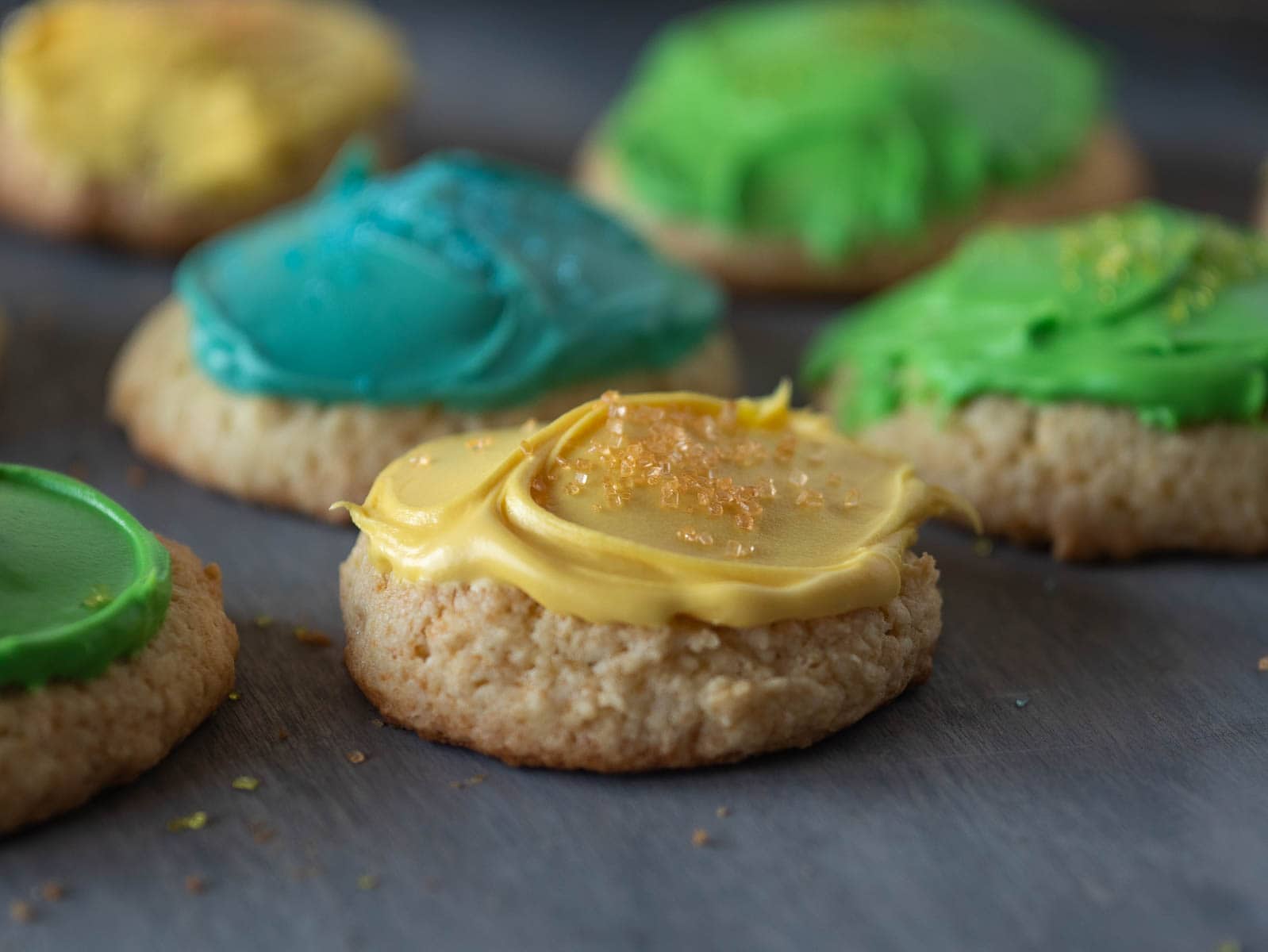 Sour cream cookies with blue, green and yellow icing.