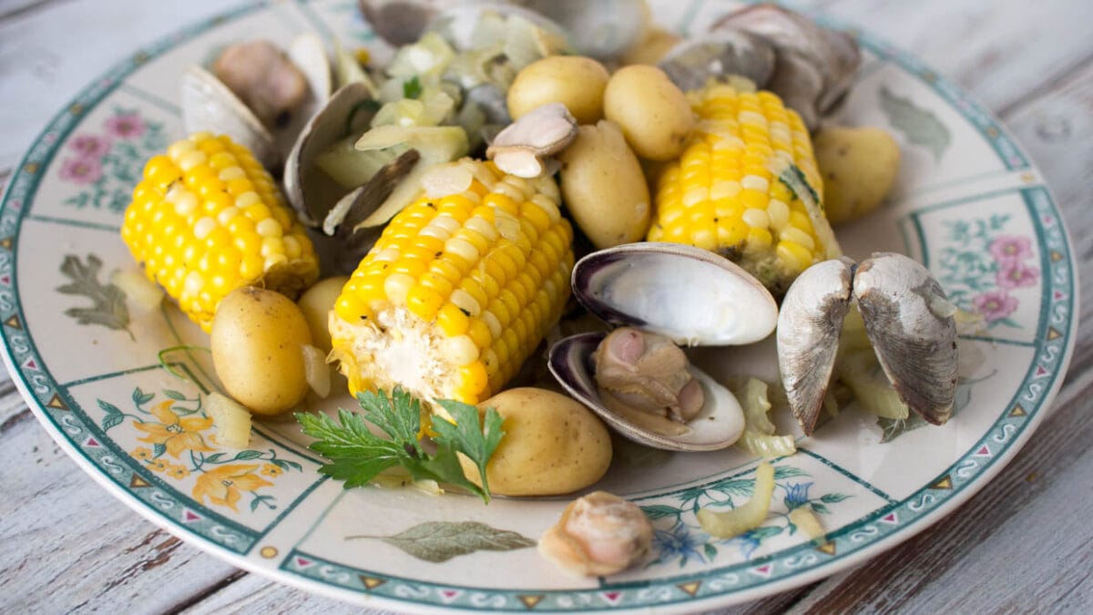 Corn, potatoes and clams on a plate.