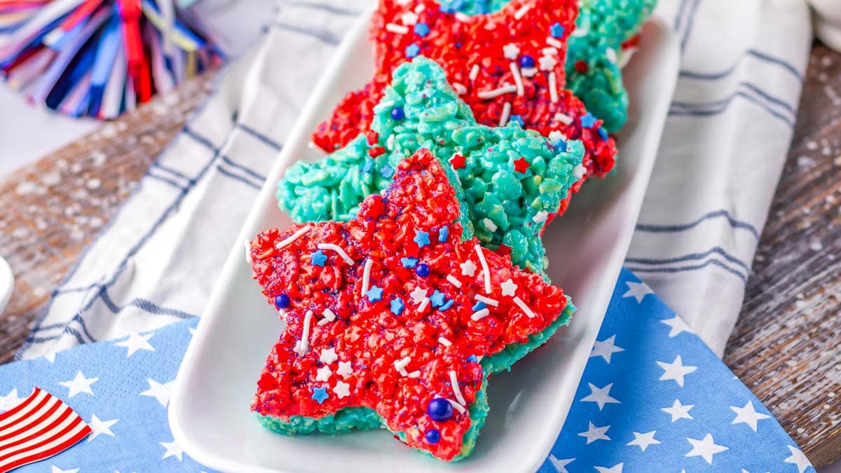 A plate of red and blue star shaped rice krispie treats.
