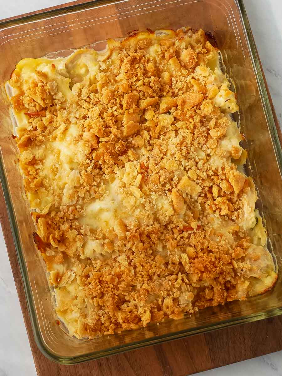 Baked chicken casserole in a glass dish with a golden, crispy crackers topping.