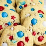 A tray of large cookies with red, white, and blue M&M candies and star-shaped decorations, labeled "Patriotic M&M Cookies." The text "quick dinner recipe" is displayed on the bottom right.
